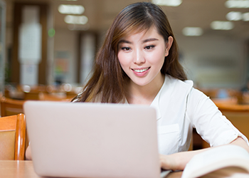 Chinese student working on laptop