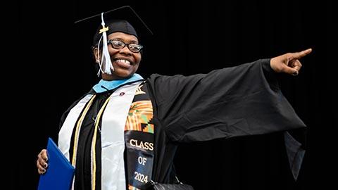 Graduate proudly holding diploma